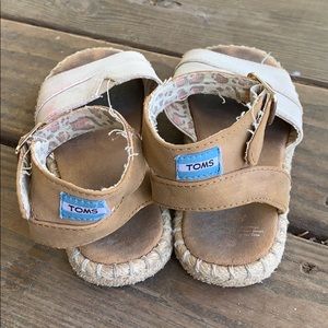 Girls play condition Toms sandals.